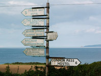 Multiple old style cast road signs on 1 post, click to enlarge.